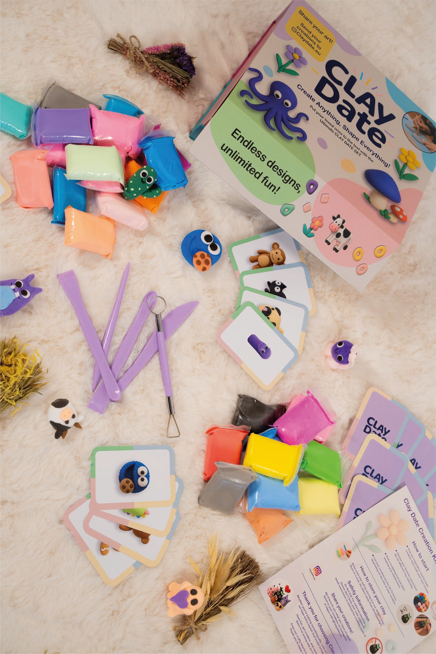 Clay Date kit with colorful clay blocks, tools, and cards on a textured surface