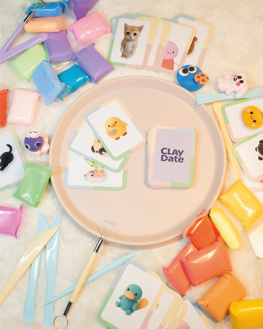 Colorful clay modeling tools and cards on a textured surface