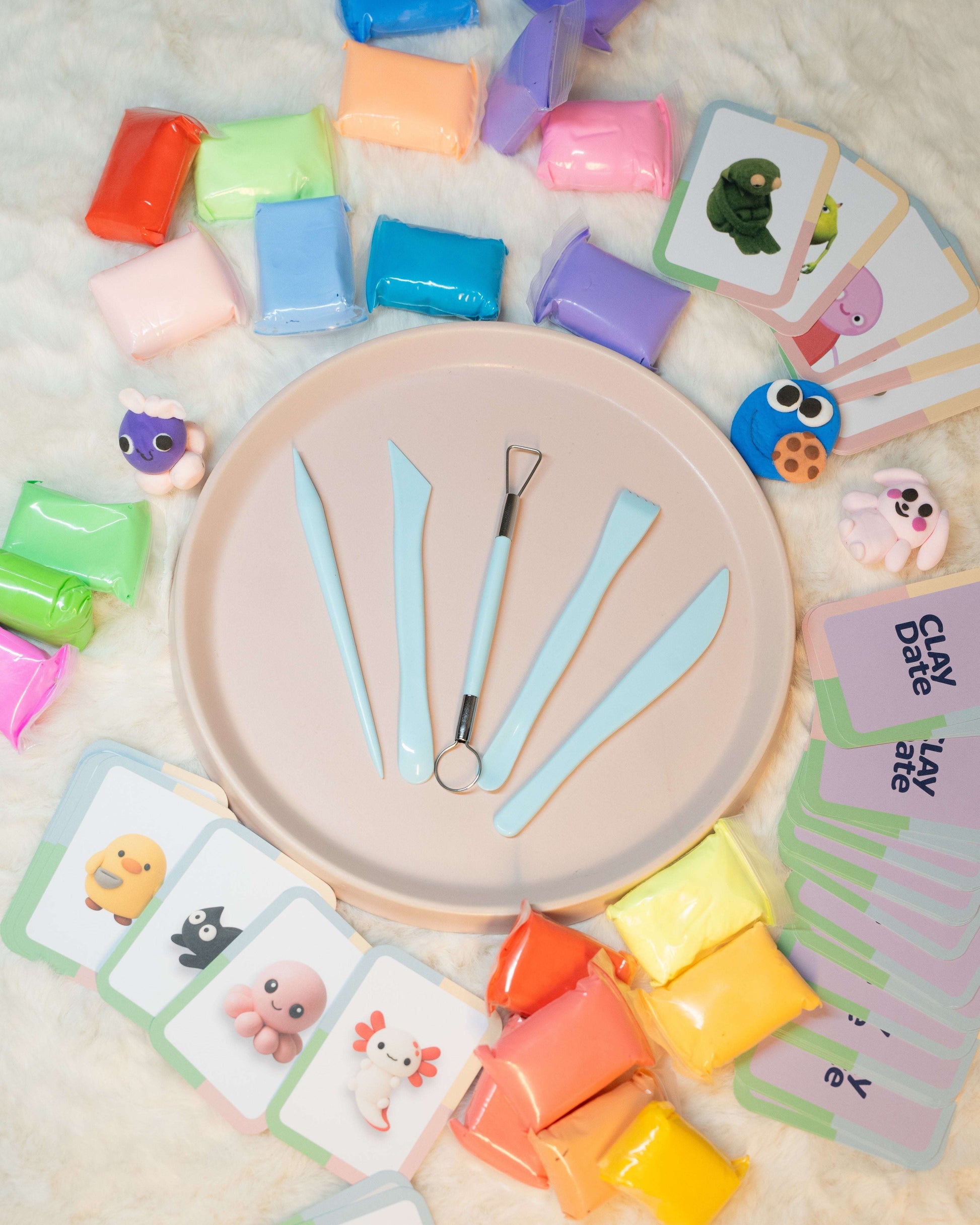 Clay Date™ Kit including cards and blocks on a soft surface.