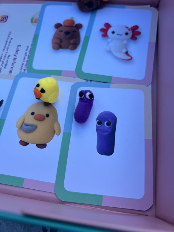 Set of cards with small animal figurines on a pink background