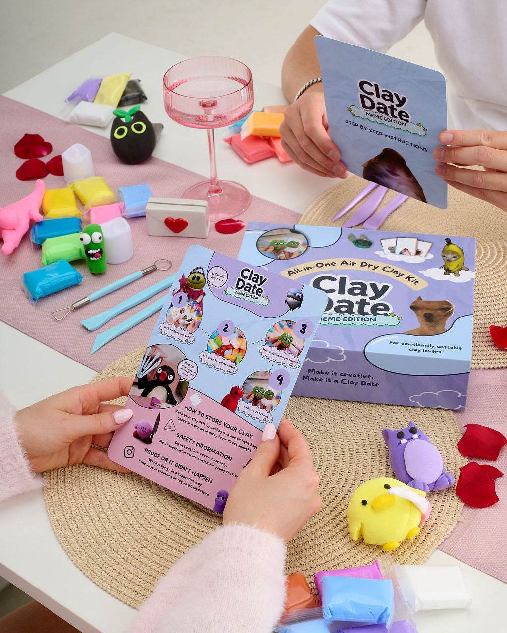 Person holding the Clay Date™ Meme Kit box with meme cards and clay pieces