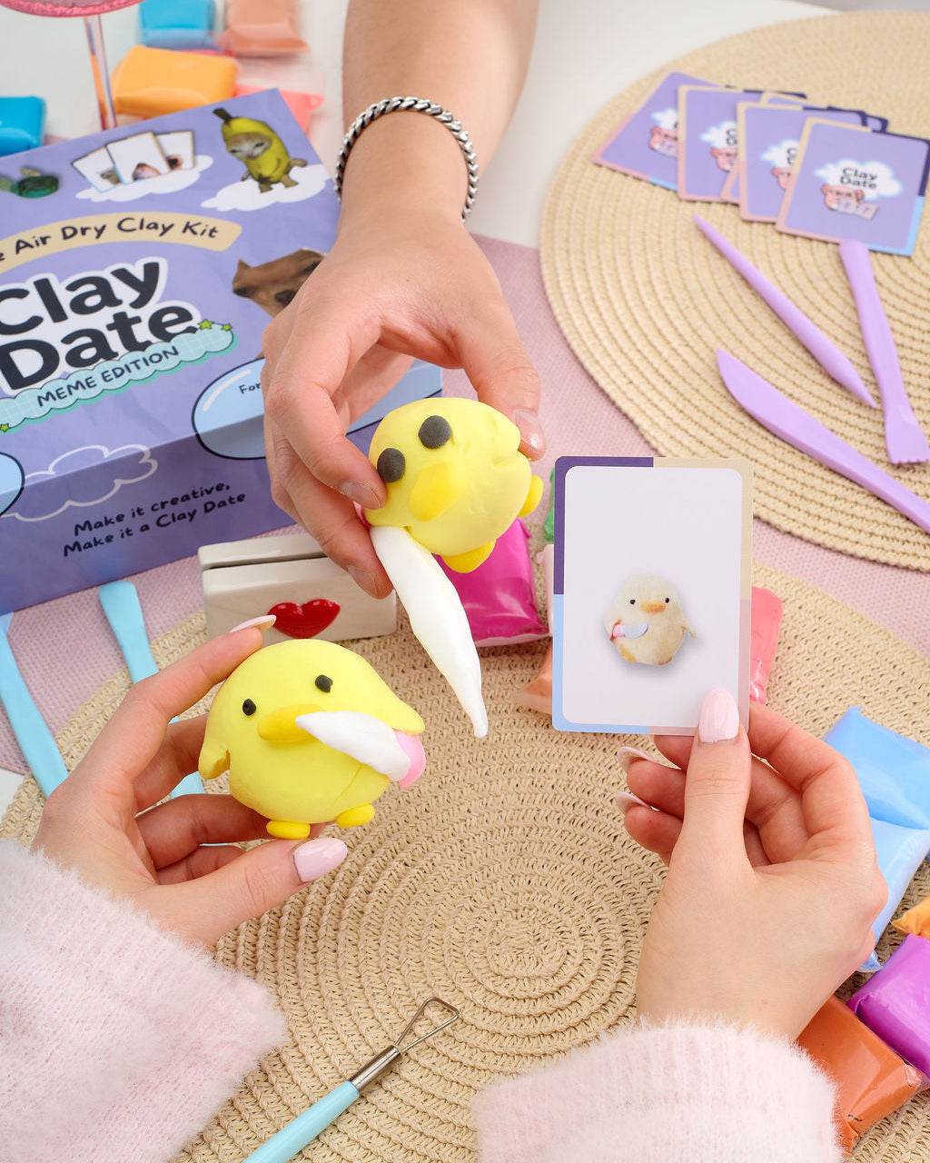 Clay creations and meme prompt cards arranged after a Clay Date™ Meme Kit session