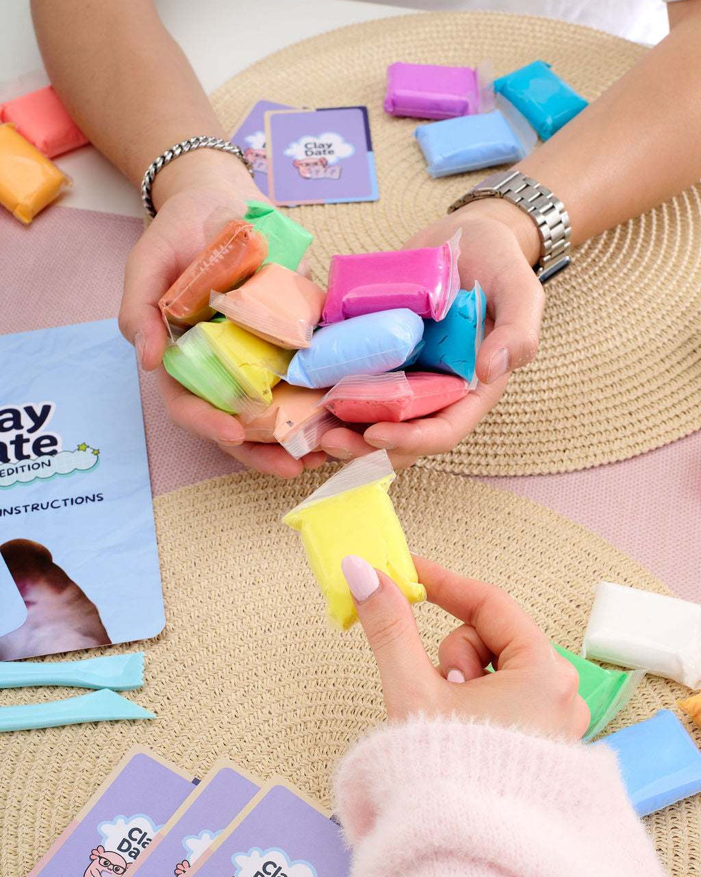 Hand holding up a completed clay creation made with the Clay Date™ Meme Kit