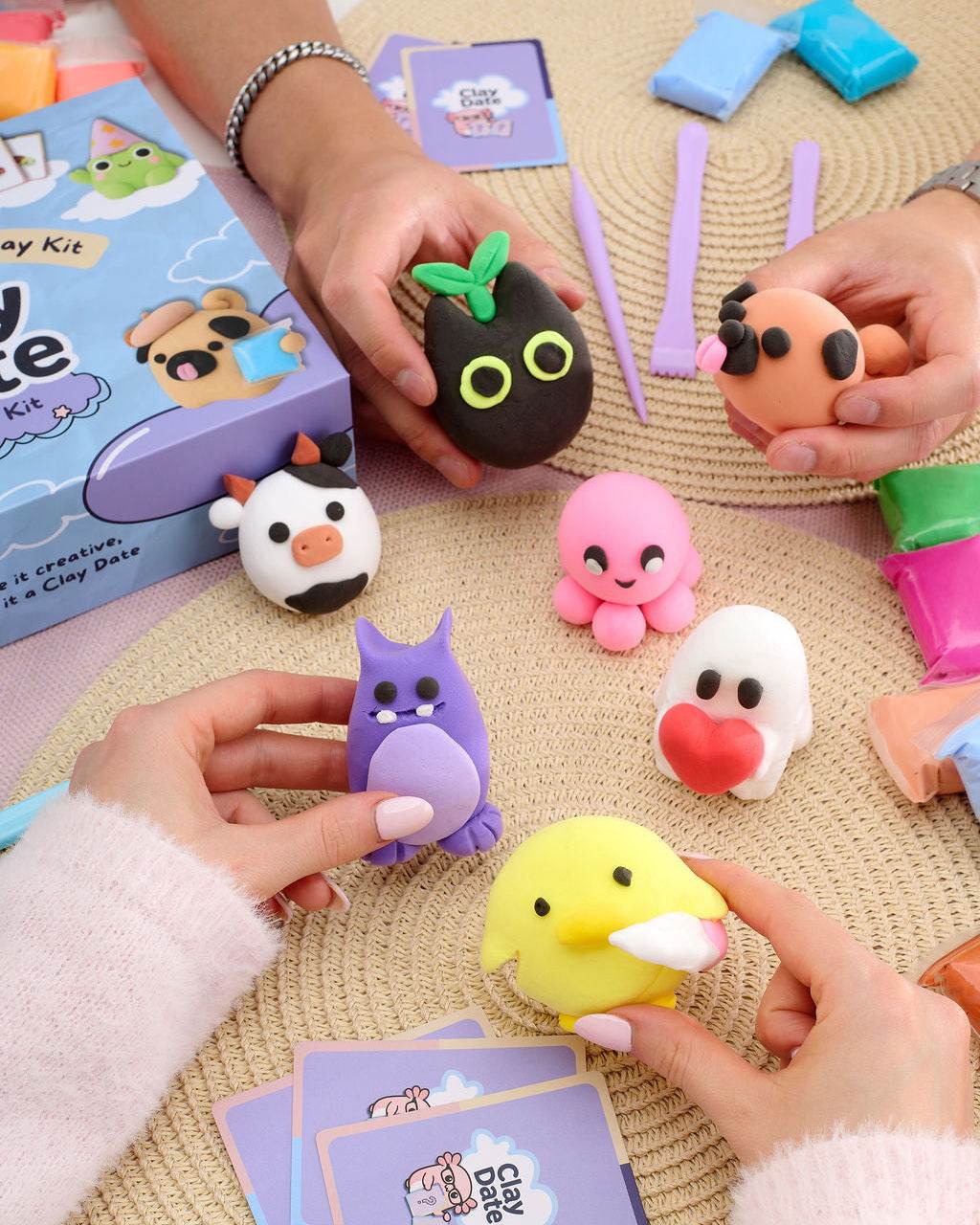Colorful clay characters and creations displayed on a table after a Clay Date New Official Kit session